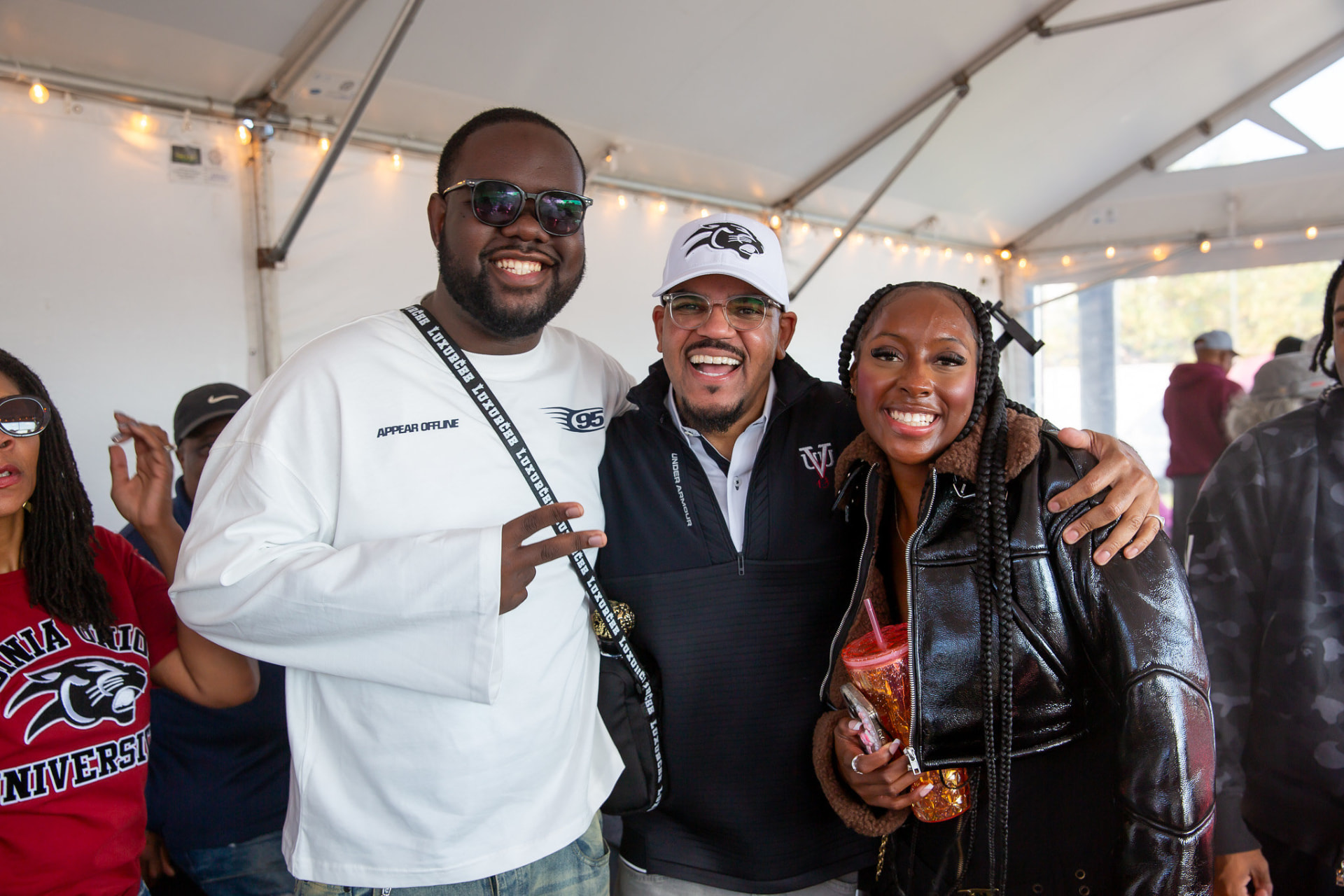 Alumni and students celebrating in the homecoming tailgate tent